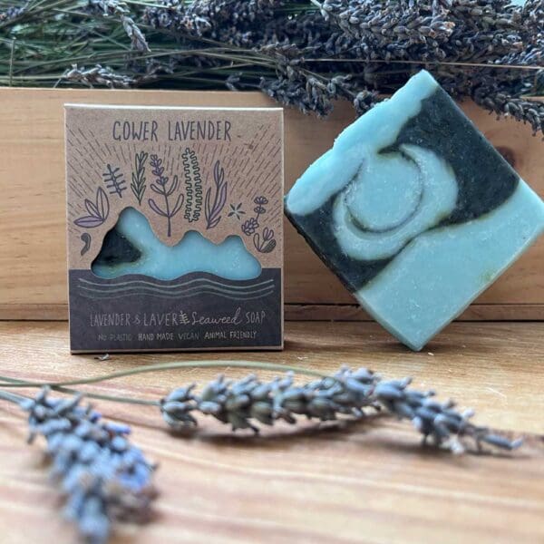 lavender soap made with local laver seaweed, displayed boxed and unboxed on a wooden table with lavender