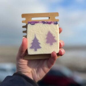 lavender soap displayed on a sustainable wooden soap dish