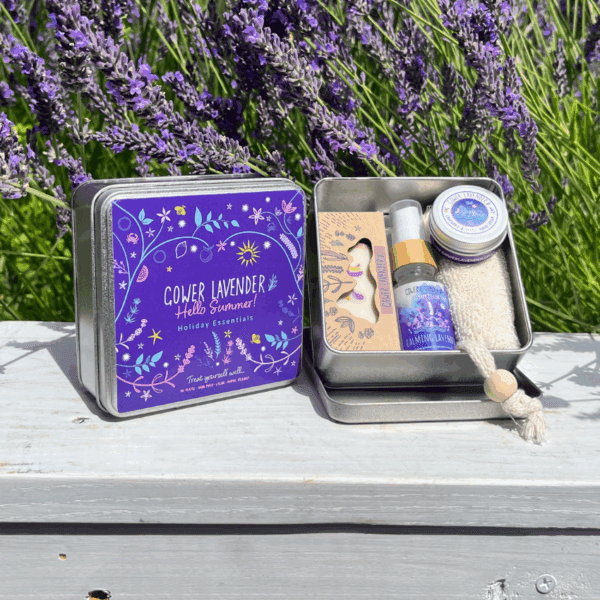 A square tin containing lavender soap, pillow spray, soap scrub and hand cream with a pretty purple label